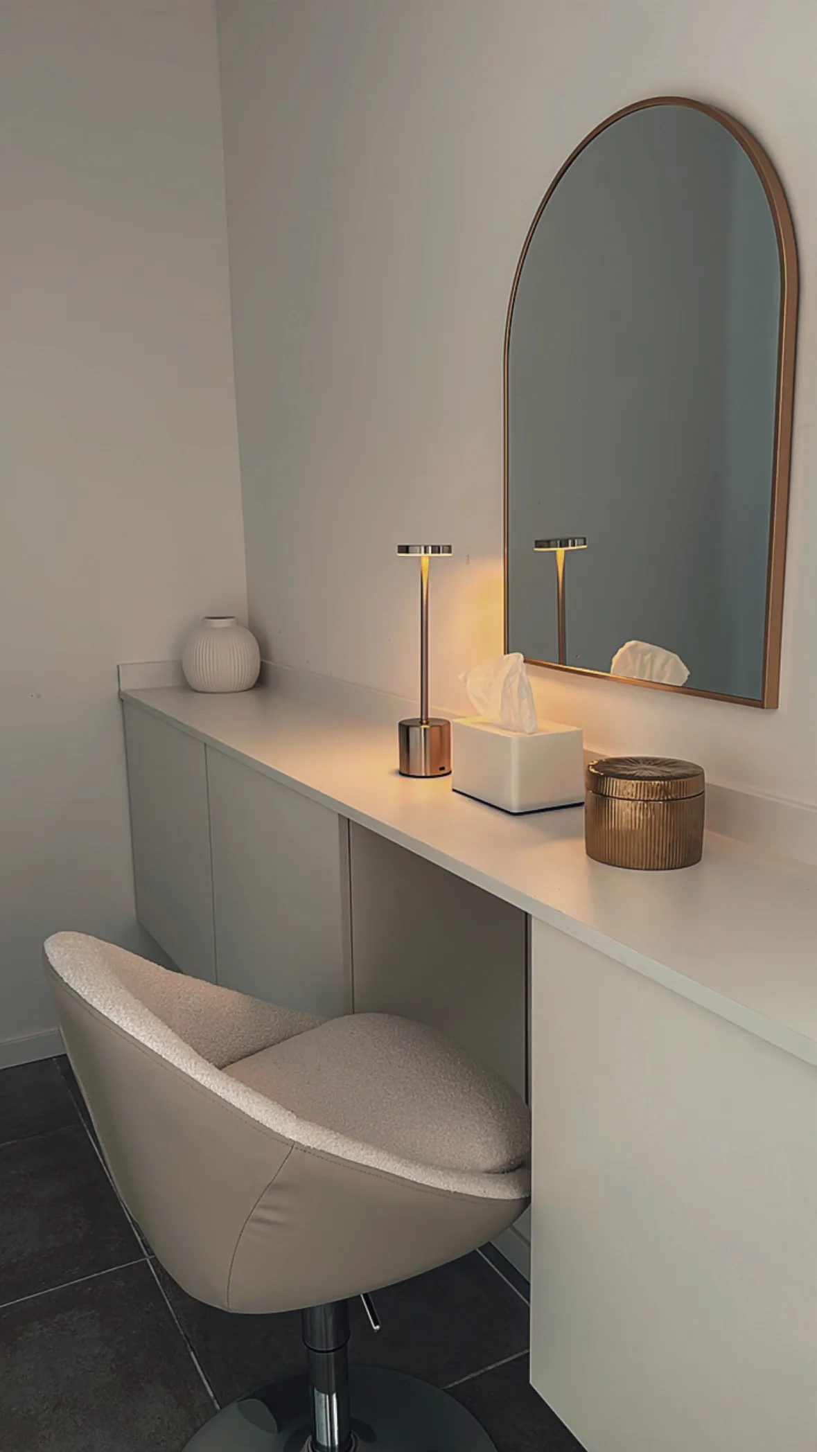 Coiffeuse et miroir arche dans l’espace de préparation